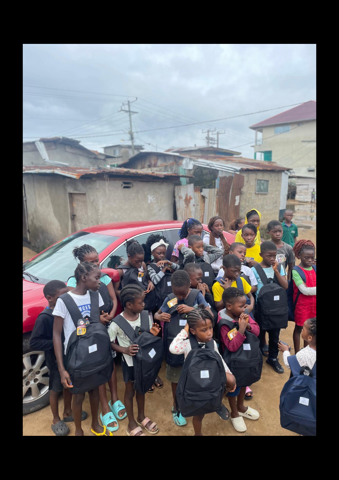 Children receiving backpacks